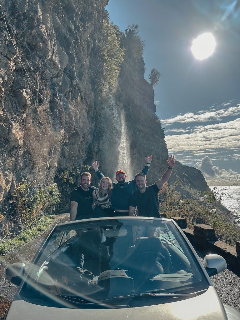 Community members in front of a waterfall